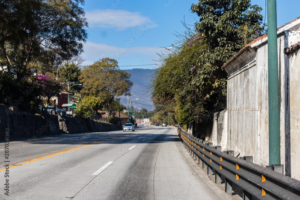 SACATEPEQUEZ, GUATEMALA - December 23, 2018: Calm traffic scene on the road between Guatemala City and Antigua on a Sunday before Christmas Day 2018.