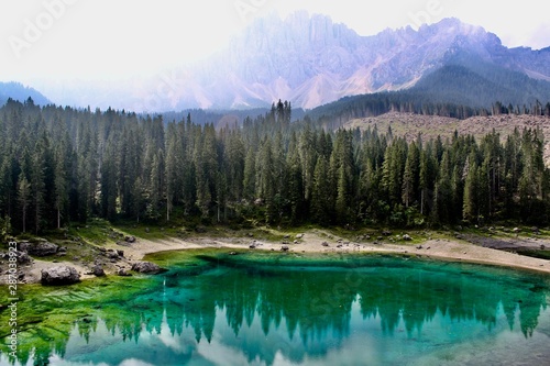 Lake Carezza, the small mountain lake is famous for the dark green color, and the beautiful panorama of mountains in the background. Legend of King Laurin and his Rosegarden. South Tyrol, Italy. I