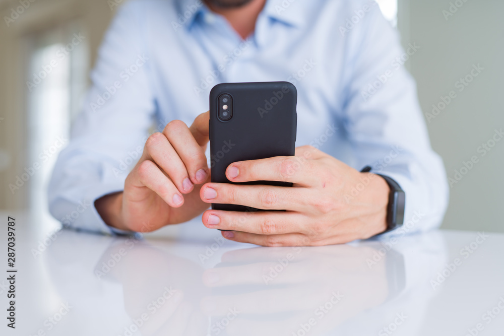 Close up of man hands using smartphone and smiling Close up of man hands using smartphone and smiling
