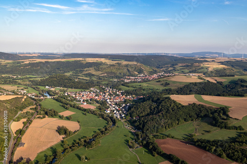 Aerial view at a landscape in Germany  Rhineland Palatinate near Bad Sobernheim with the river Nahe  the village Staudernheim  meadow  farmland  forest  hills  mountains