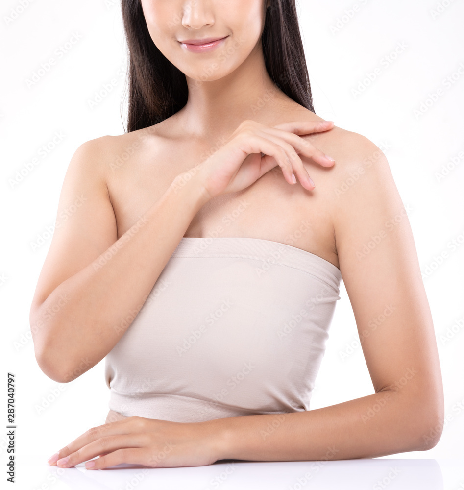 Beautiful Young Asian Woman Looking While Touching Shoulder feeling so happy and cheerful with healthy Clean and Fresh skin,isolated on white background,Beauty Cosmetology Concept