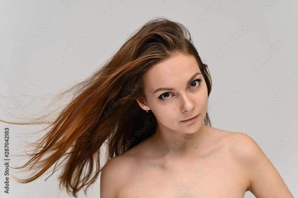 Close-up Portrait of a cute brunette girl, a young woman with beautiful curly hair and beautiful face skin. Beauty, brightness, smile, health. Close-up Portrait of a cute brunette girl, a young woman with beautiful curly hair and beautiful face skin. Beauty, brightness, smile, health.