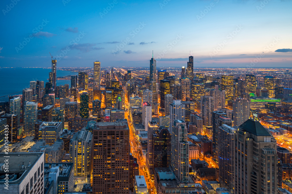 Beautiful scenic view of business district of Chicago loop with skyline in evening sunlight. Panoramic view aerial top view or drone architecture view of city. Famous attraction in Chicago, USA.