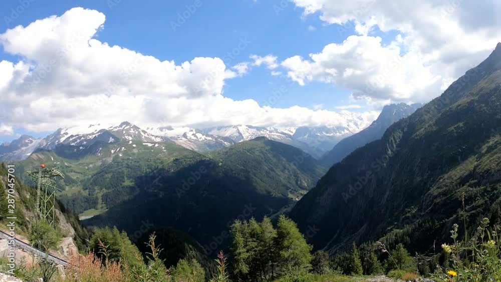 A breeze sways grassy plants on the side of a mountain. Movement of the view to the horizon. Chamonix, France A breeze sways grassy plants on the side of a mountain. Movement of the view to the horizon. Chamonix, France