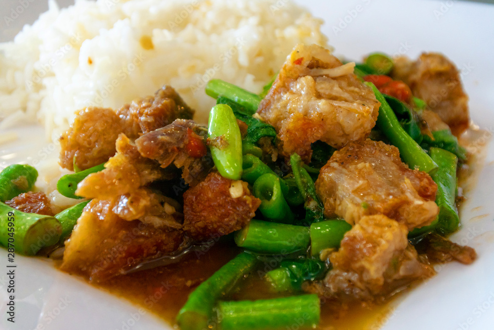 Close-up of Fried crispy pork with basil leaves and rice,Thai Food Close-up of Fried crispy pork with basil leaves and rice,Thai Food
