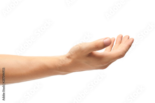 Young man held out hand on white background, closeup