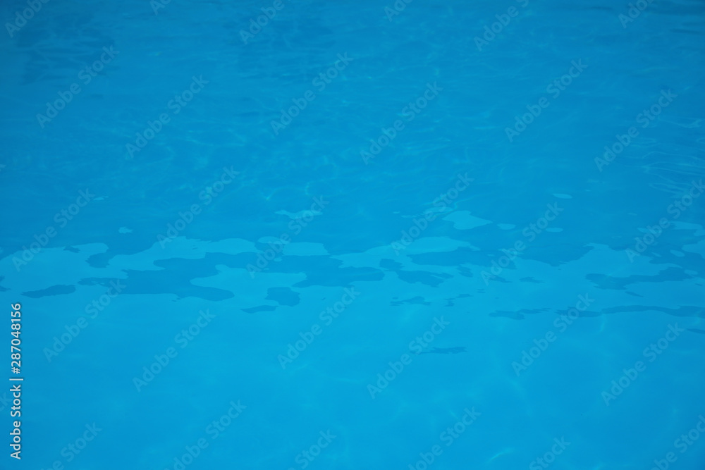 Surface of swimming pool with clean blue water as background