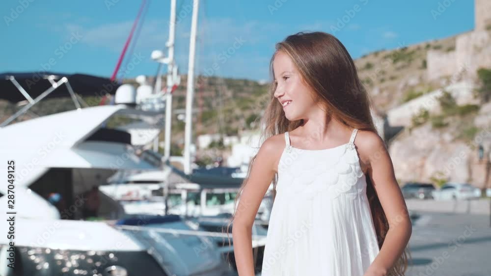 Preteen girl with long hair standing near boat Stock Video | Adobe Stock