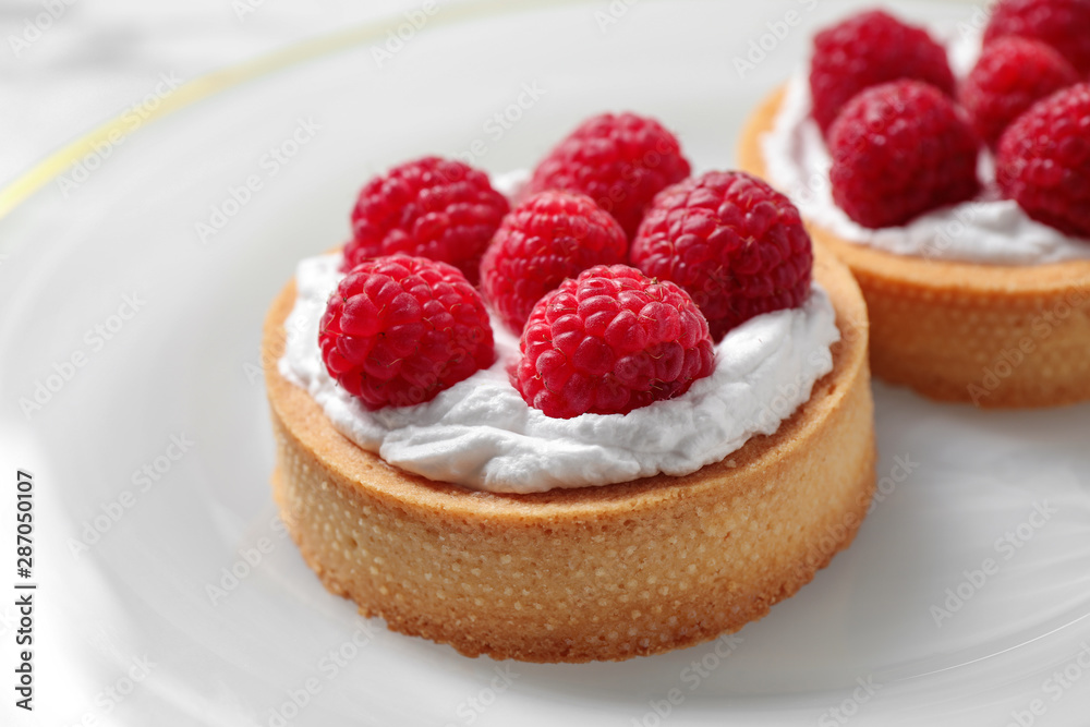 Plate with raspberry tarts, closeup. Delicious pastries Plate with raspberry tarts, closeup. Delicious pastries