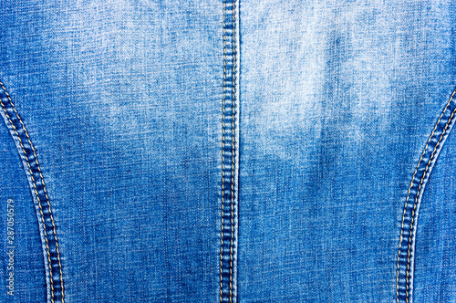 clothing items blue stonewashed faded jeans cotton fabric texture with seams, clasps, buttons and rivets, macro, close-up