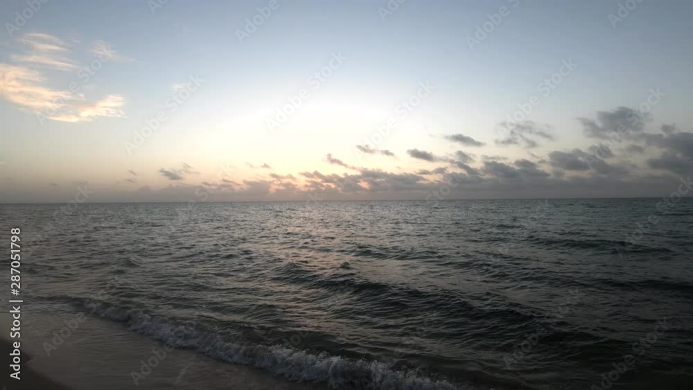 4K Slow motion ascending view of fine sand shore hit by gentle Atlantic ocean waves at sunrise, Miami Beach, Florida 4K Slow motion ascending view of fine sand shore hit by gentle Atlantic ocean waves at sunrise, Miami Beach, Florida