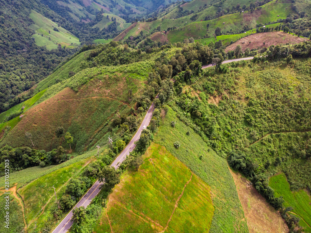 Aerial view Road on the top of a hill with lush greenery The atmosphere of the morning with fog Suitable for driving holiday travel. Aerial view Road on the top of a hill with lush greenery The atmosphere of the morning with fog Suitable for driving holiday travel.