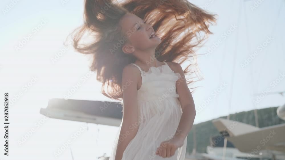 Preteen girl laughing and heaving fun outside Stock Video | Adobe Stock->