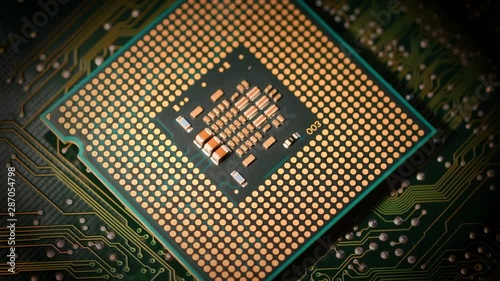closeup of CPU Chip over electronic circuit board rotating on dolly.