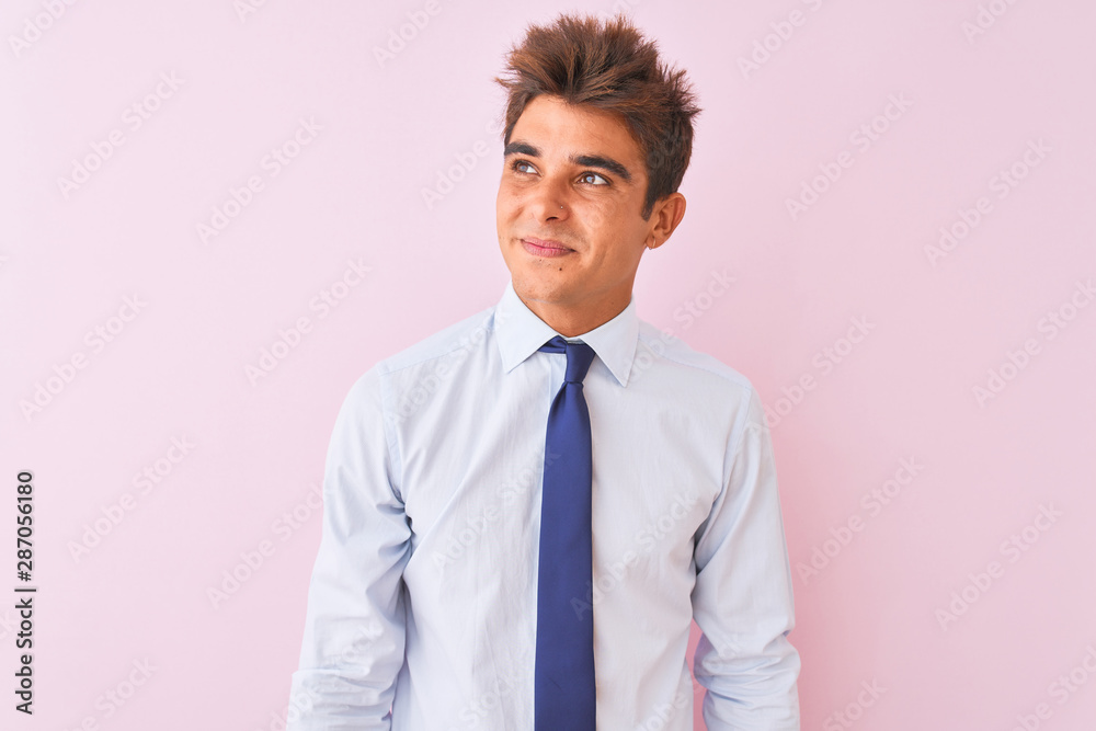 Young handsome businessman wearing shirt and tie standing over isolated pink background smiling looking to the side and staring away thinking. Young handsome businessman wearing shirt and tie standing over isolated pink background smiling looking to the side and staring away thinking.