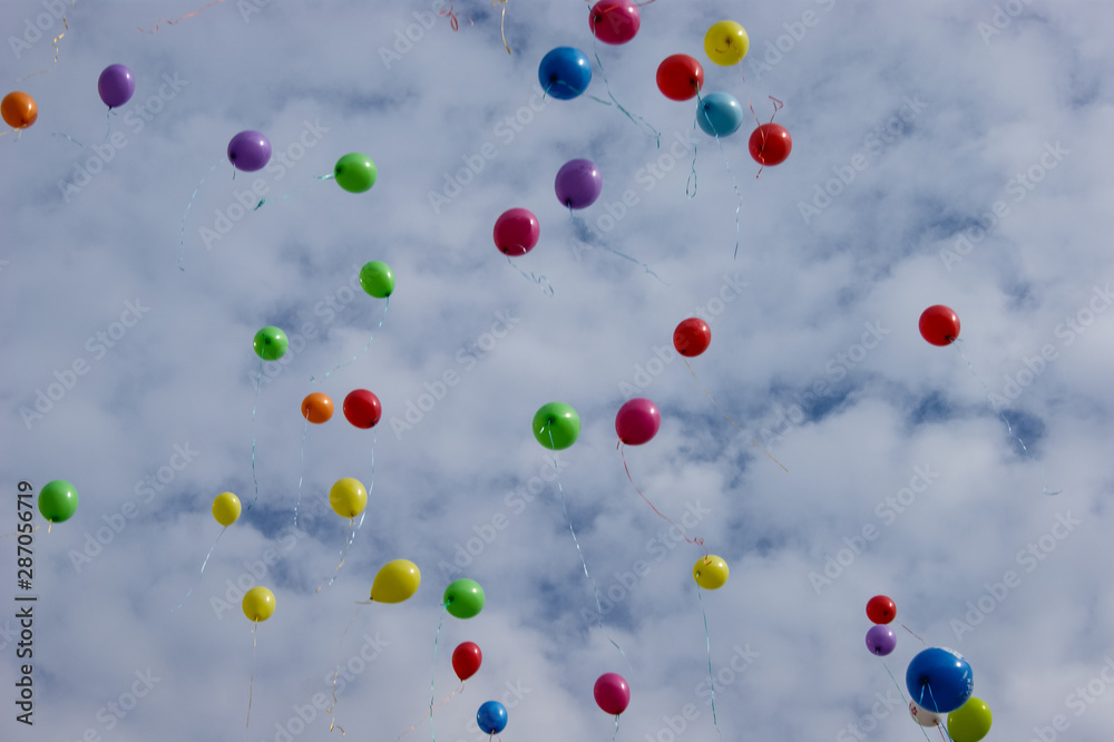 Multi-colored balloons in the sky with clouds Multi-colored balloons in the sky with clouds