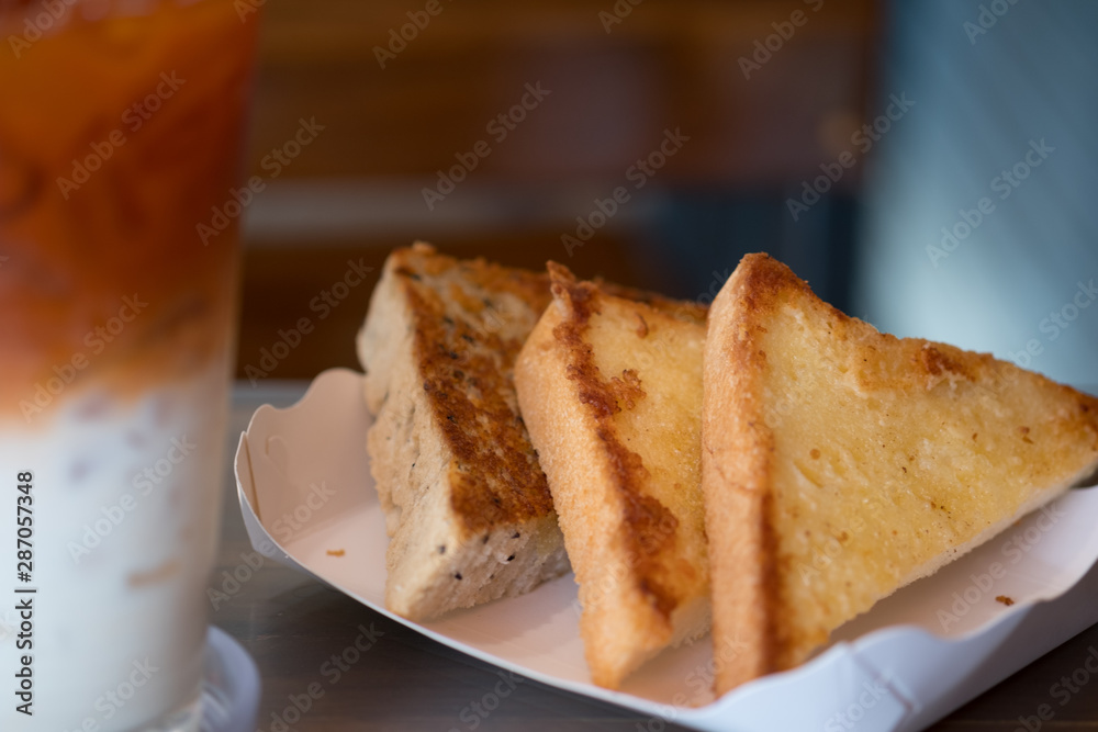 Triangle of garlic bread in white paper tray Triangle of garlic bread in white paper tray
