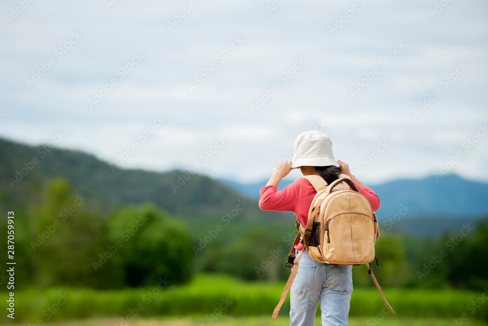 Relax Little girl with backpack walking in to nature park , Travel education lifestyle concept. Relax Little girl with backpack walking in to nature park , Travel education lifestyle concept.