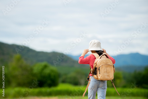 Relax Little girl with backpack walking in to nature park , Travel education lifestyle concept.