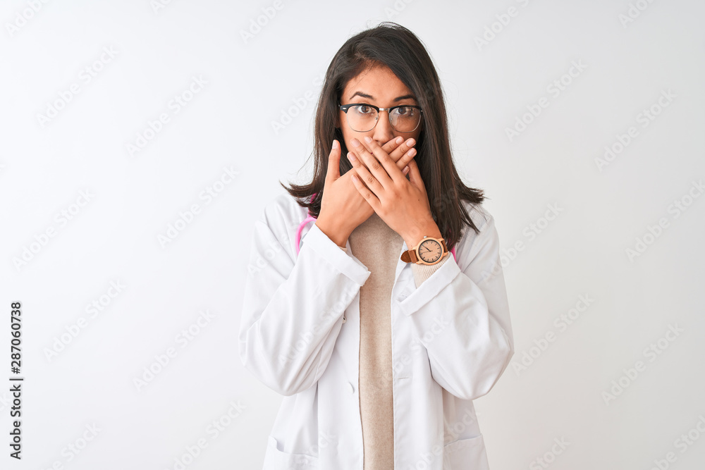 Chinese doctor woman wearing coat and pink stethoscope over isolated white background shocked covering mouth with hands for mistake. Secret concept. Chinese doctor woman wearing coat and pink stethoscope over isolated white background shocked covering mouth with hands for mistake. Secret concept.
