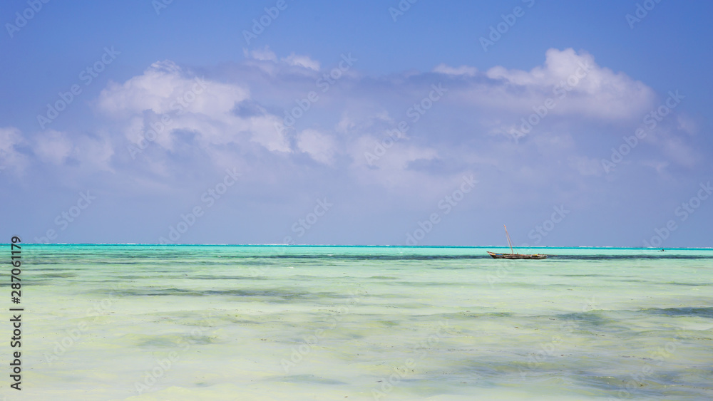 Wooden Fishing Boat in turquoise waters of Indian ocean,Zanzibar,Tanzania