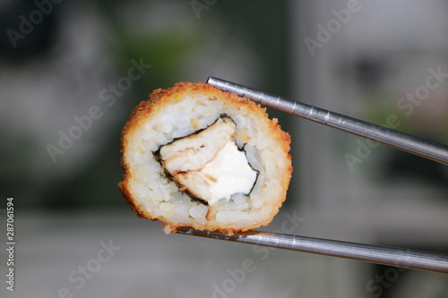sushi on chop sticks