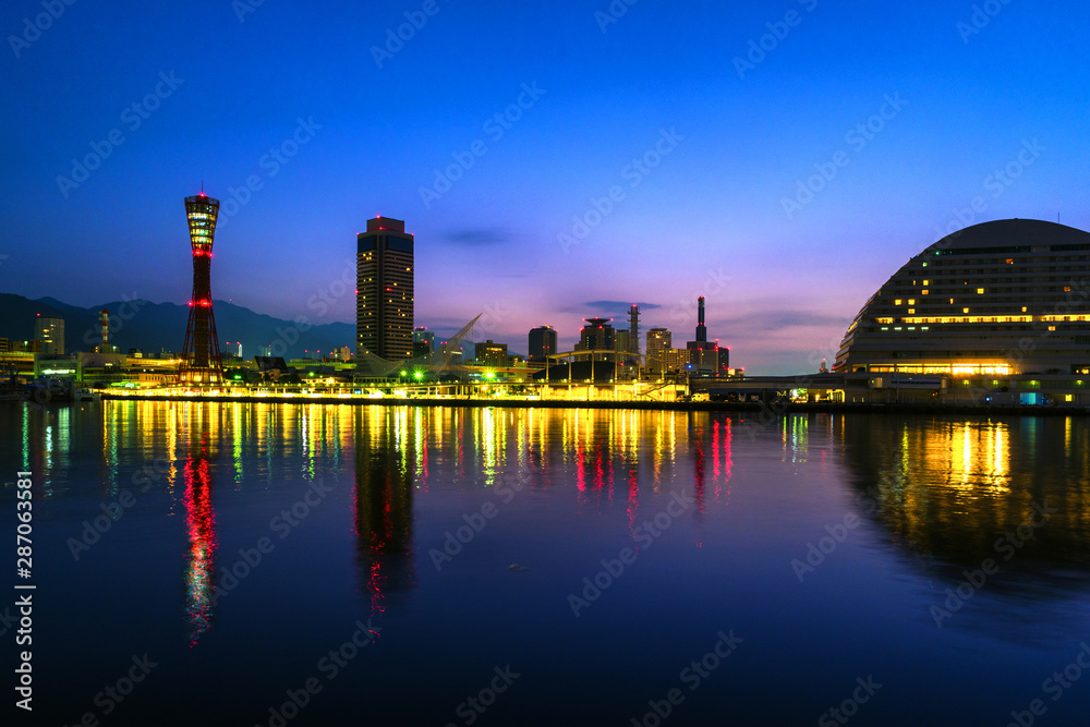 View of night in Kobe, Japan. Cloudless sky with harbor and numerous skyscrapers