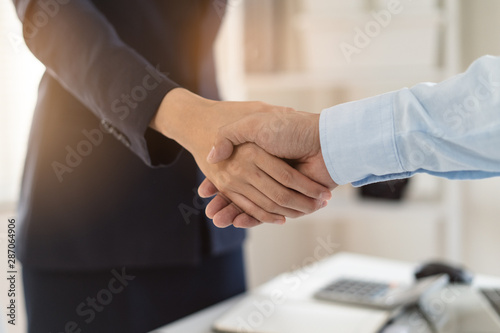 Business partner confirm deal agreement. Businesswoman and client shaking hands together in meeting in offfice.