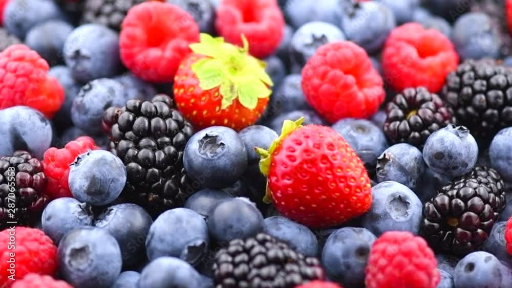 Berries. Various colorful berries background. Strawberry, raspberry, blackberry, blueberry closeup over black. Healthy eating. Rotation. Slow motion 4K UHD video footage. 3840X2160 Berries. Various colorful berries background. Strawberry, raspberry, blackberry, blueberry closeup over black. Healthy eating. Rotation. Slow motion 4K UHD video footage. 3840X2160