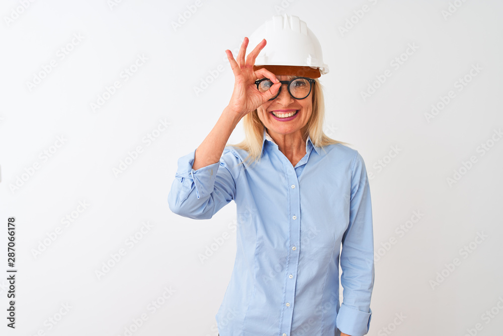 Middle age architect woman wearing glasses and helmet over isolated white background doing ok gesture with hand smiling, eye looking through fingers with happy face. Middle age architect woman wearing glasses and helmet over isolated white background doing ok gesture with hand smiling, eye looking through fingers with happy face.
