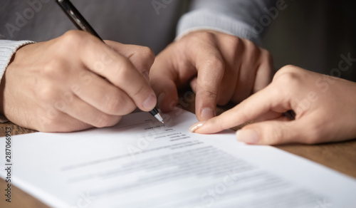 Male customer write signature on contract meeting lawyer solicitor