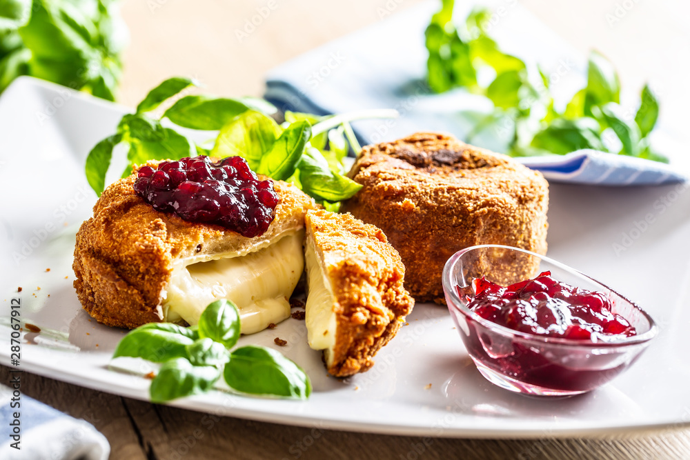 Fried camembert or brie cheese with cranberry jam and basil Fried camembert or brie cheese with cranberry jam and basil
