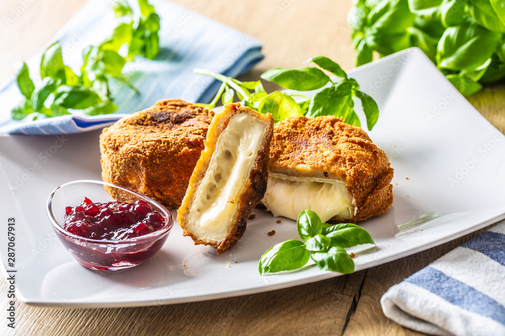 Fried camembert or brie cheese with cranberry jam and basil