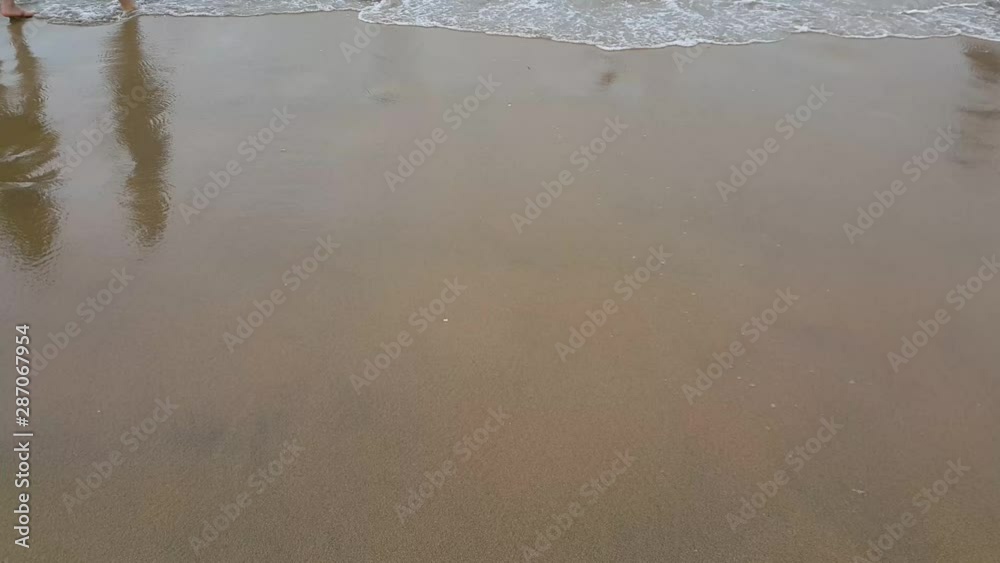 Ocean waves moving back and forth over sandy shore land. View of beach sea on sun light in the summer. Ocean waves moving back and forth over sandy shore land. View of beach sea on sun light in the summer.