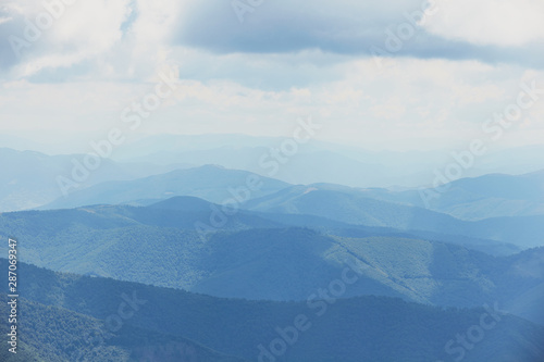 Mountain landscape of blue hills on the background of cloudy sky