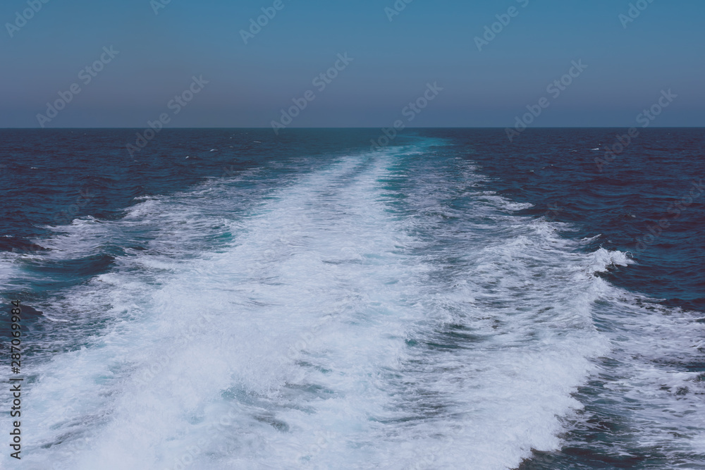 Creative layout made of clear sea watersurface with kelvou jet, bubbles and waves on water surface with copy space, toned Creative layout made of clear sea watersurface with kelvou jet, bubbles and waves on water surface with copy space, toned