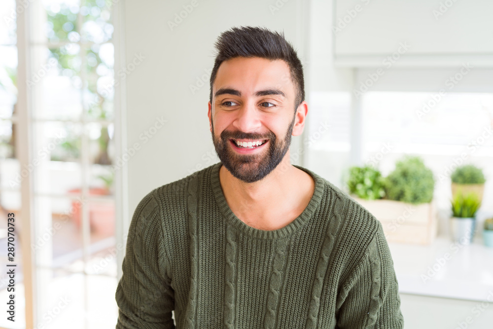 Handsome man smiling cheerful with a big smile on face showing teeth, positive and happy expression Handsome man smiling cheerful with a big smile on face showing teeth, positive and happy expression