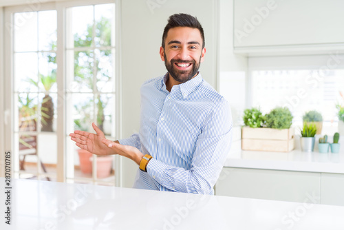 Handsome hispanic business man Inviting to enter smiling natural with open hand