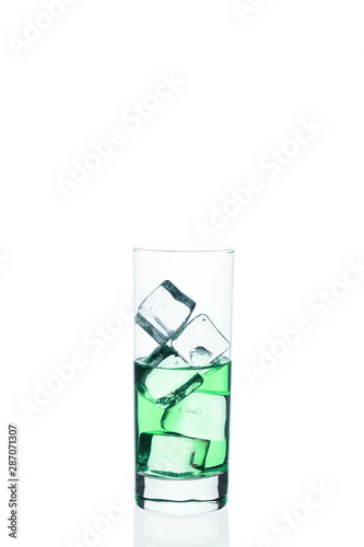 .Glass beaker is filled with a blue cocktail ice cubes on a white background.