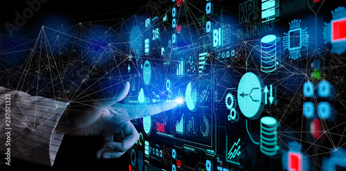 Business data analytics process management with businesswoman hand touching connected gear cogs with KPI financial charts and graph and automated marketing dashboard.