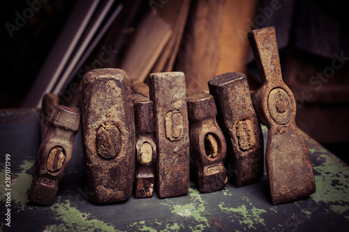 set of old hammers and rusty nails. tools on metal the surface.