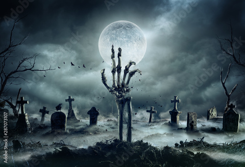 Valokuvatapetti Skeleton Zombie Hand Rising Out Of A GraveYard - Halloween