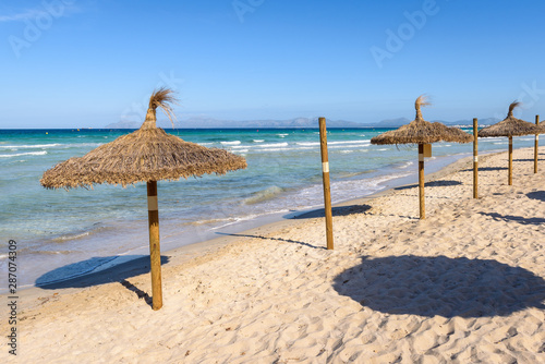 Umbrellas at the Playa de Muro beach in Mallorca  Spain