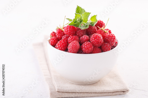 fresh raspberries with mint in a white Cup