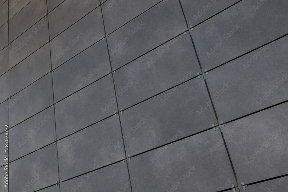 Diagonal view of smooth gray rectangular tile on wall, for background or design Diagonal view of smooth gray rectangular tile on wall, for background or design