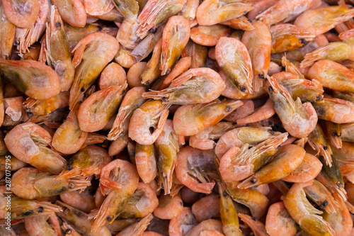 Frozen shrimps in one huge pile, seafood background for sustainable healthy diet.
