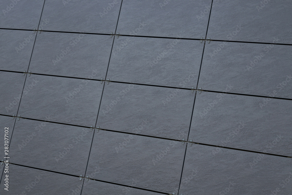 Dark gray tiled wall on building facade, exterior design option Dark gray tiled wall on building facade, exterior design option
