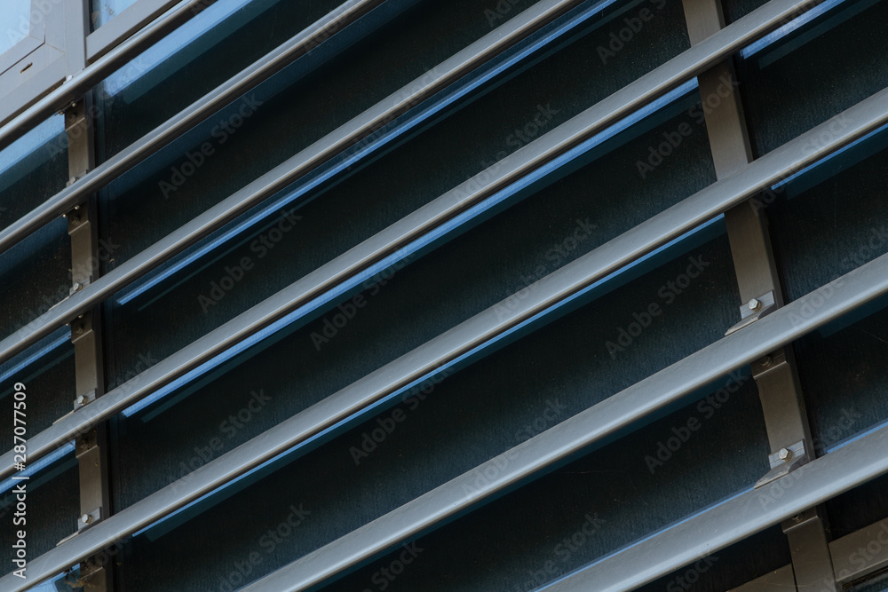 Dark building facade with brown corrugated panels, shutterlike
