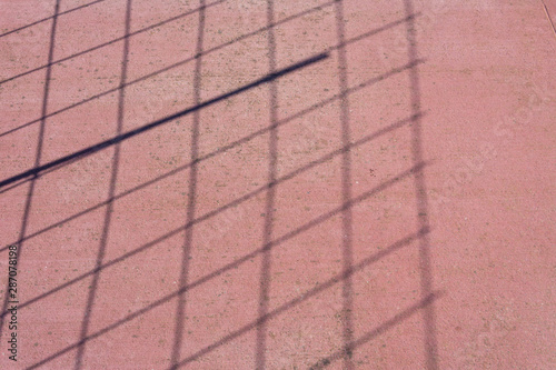 Wallpaper Mural the shadow of a square grating on a coral-colored concrete sidewalk Torontodigital.ca