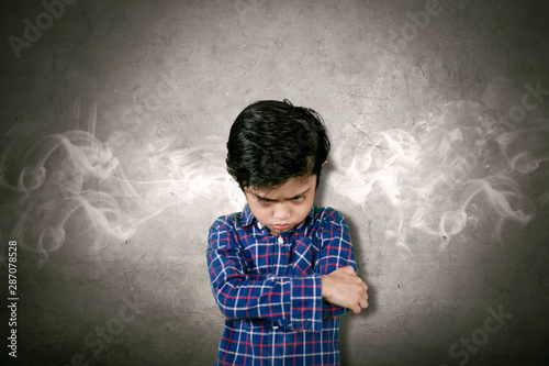 Bilde på lerret Angry little boy with smoke coming out of his head